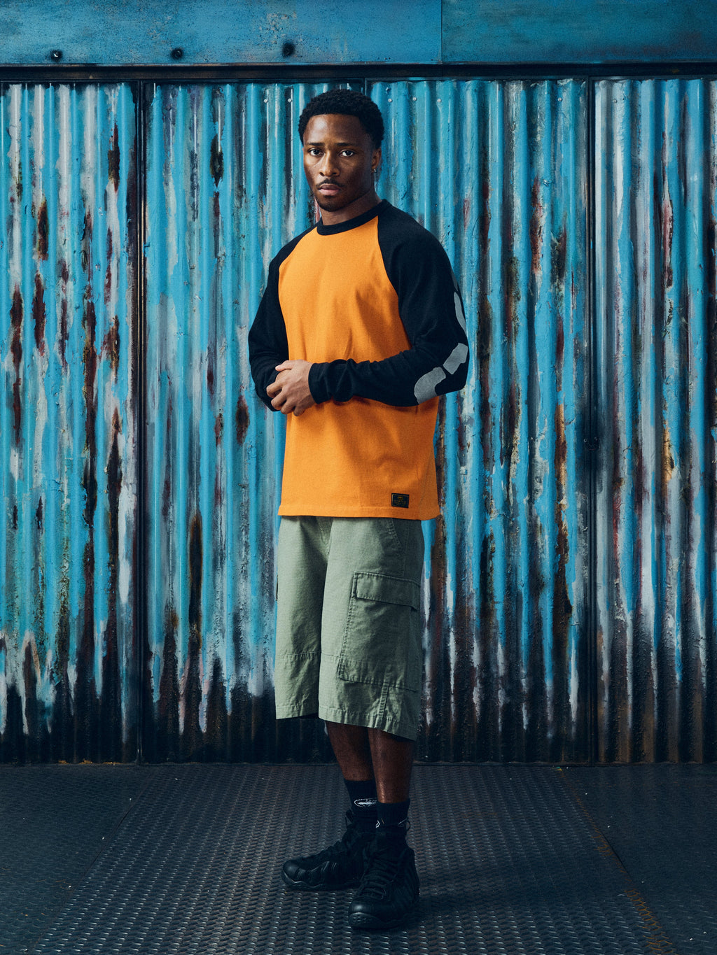 CORTEIZ Stencil Raglan Long Sleeve — Orange/Black — styled view