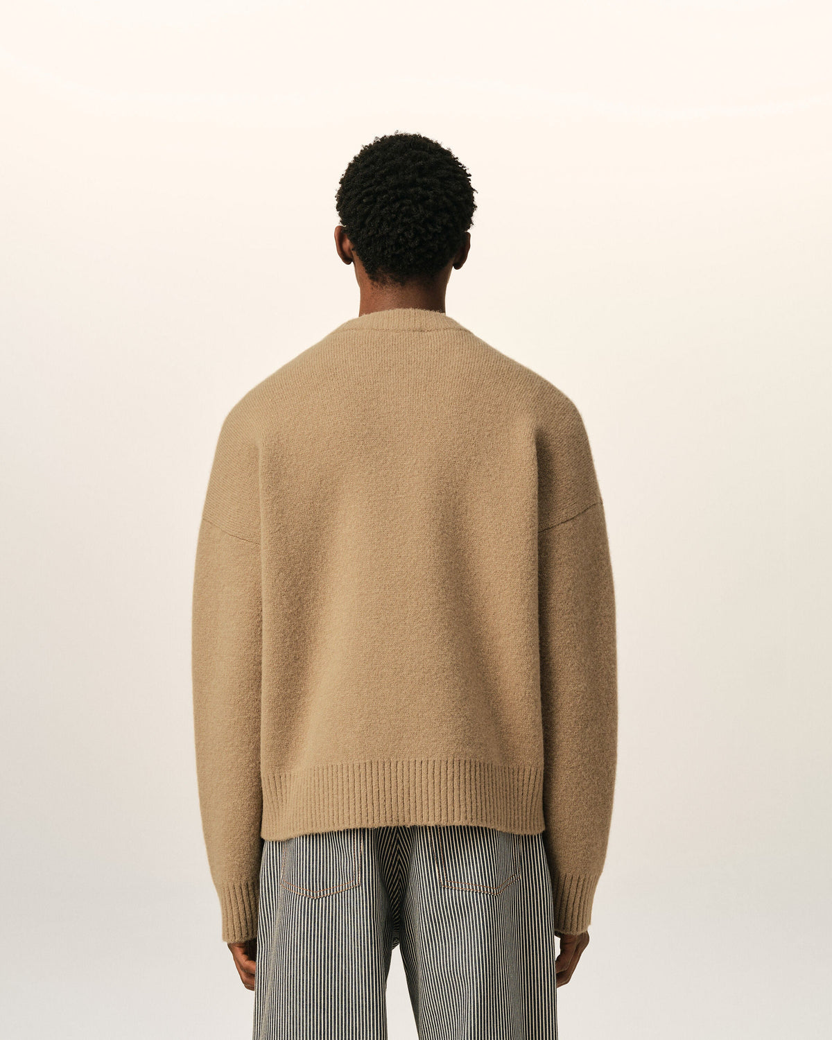 AMI Paris Ami de Cœur Textured Logo Crewneck Sweater — Camel / Ivory — styled back view