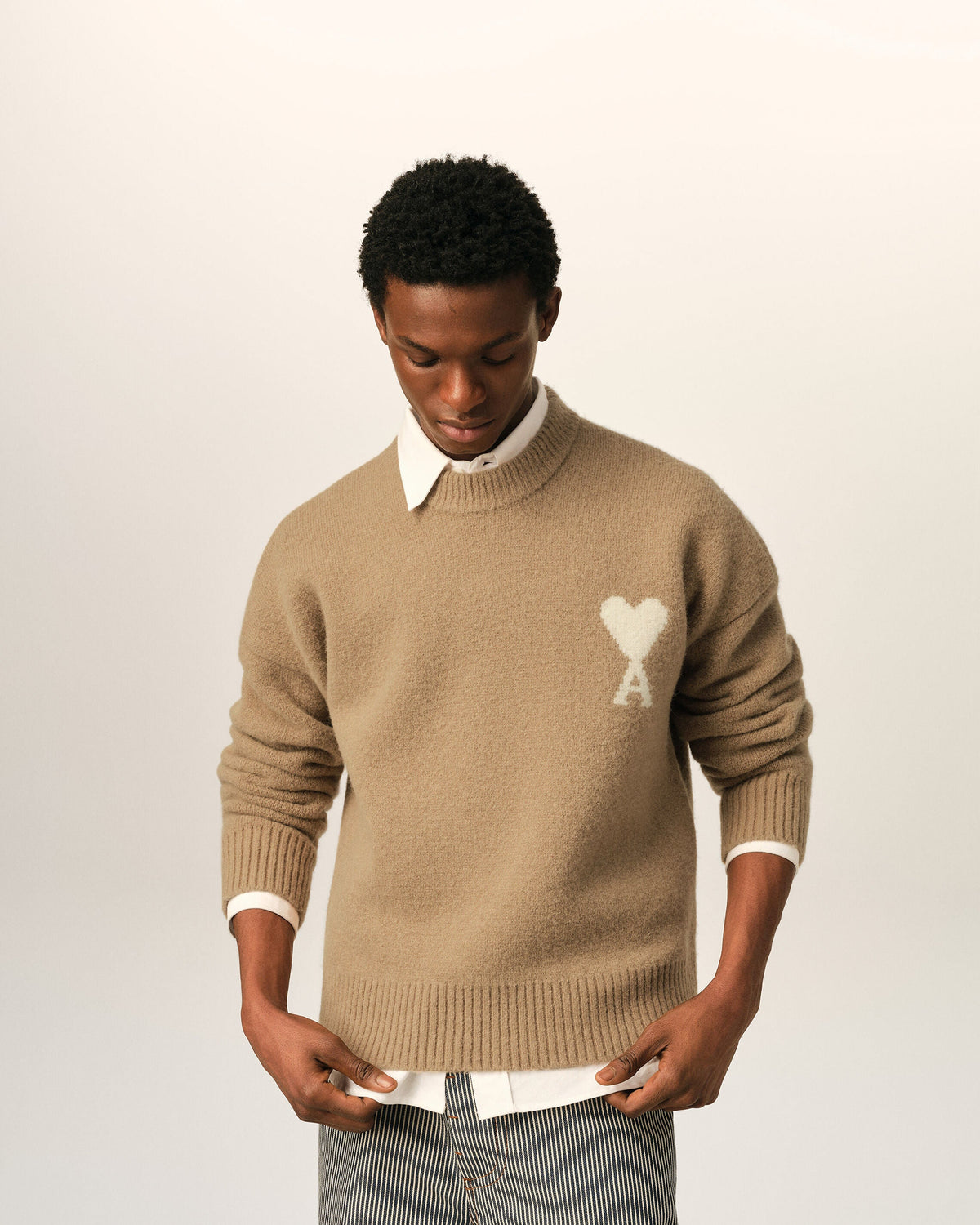 AMI Paris Ami de Cœur Textured Logo Crewneck Sweater — Camel / Ivory — styled front view